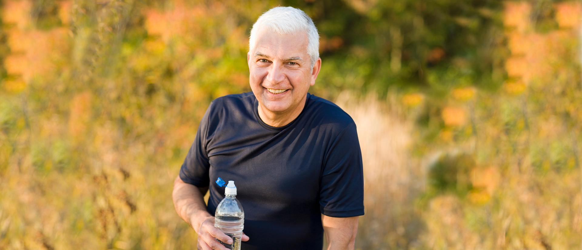 man outside with water bottle
